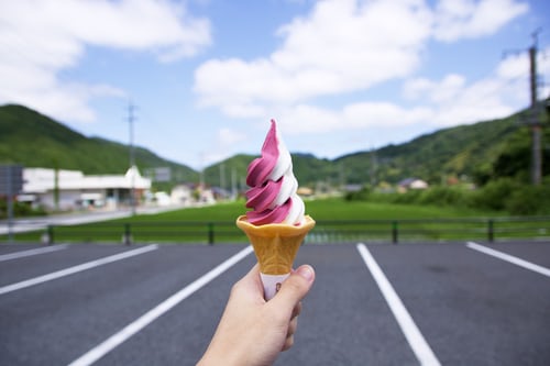 Someone is holding an ice cream in his hands.